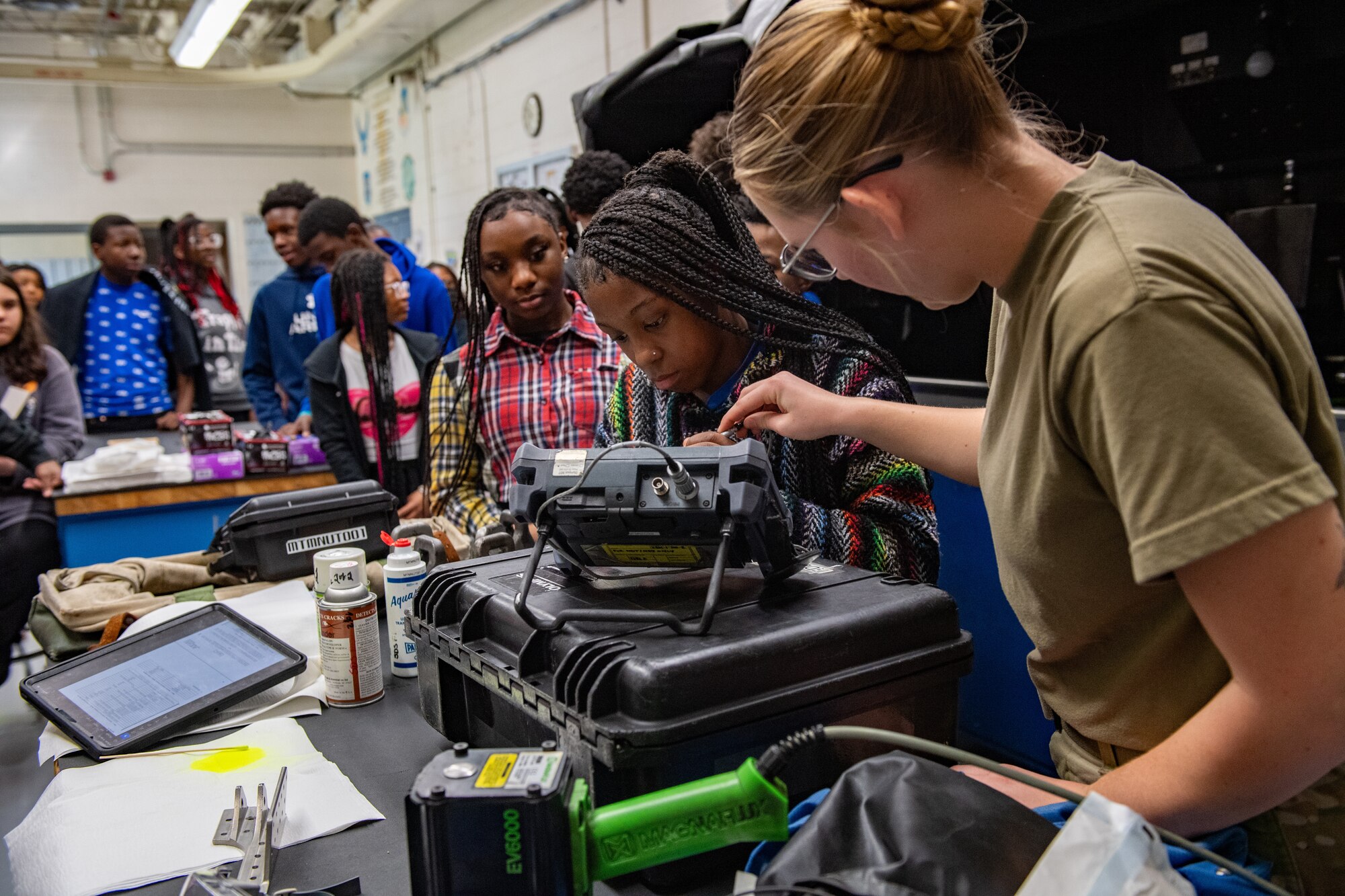 U.S. Air Force Airman 1st Class Aubrey Baird, 23rd Maintenance Squadron nondestructive inspection journeyman, assists a Valdosta Middle School student with a hands-on demonstration at Moody Air Force Base, Georgia, March 15, 2024. The students toured an array of squadrons at Moody AFB during Women in Aviation Week. Team Moody’s annual WIA events aim to highlight aviation-related career fields and inspire local youth to consider futures in the Air Force.  (U.S. Air Force photo by Senior Airman Courtney Sebastianelli)