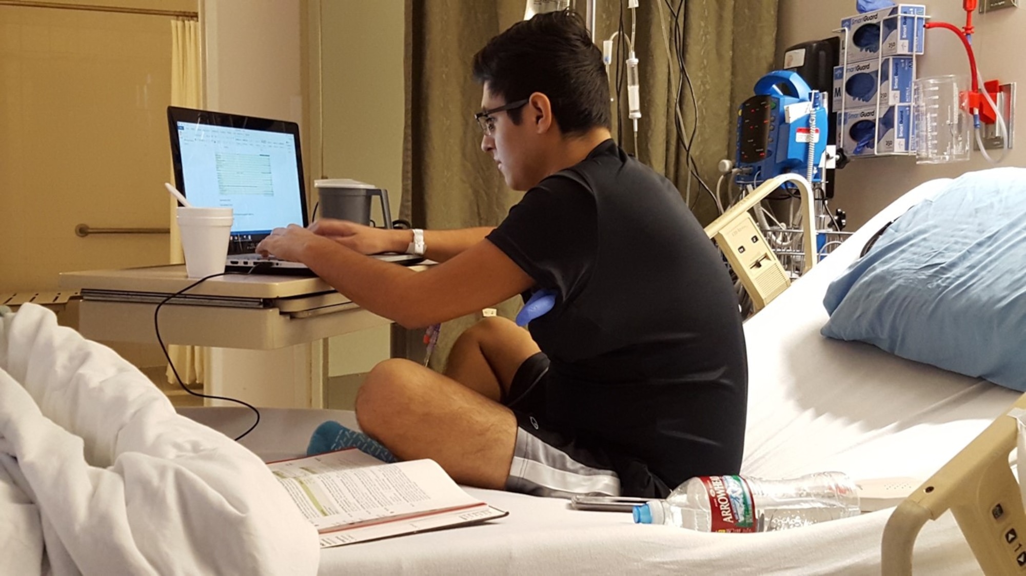 Michael Chacon works on completing his college requirements while receiving cancer treatment in the hospital in 2016. Chacon is currently an Officer Trainee attending Officer Training School before returning to his Air National Guard unit an completing training requirements to be an intelligence officer