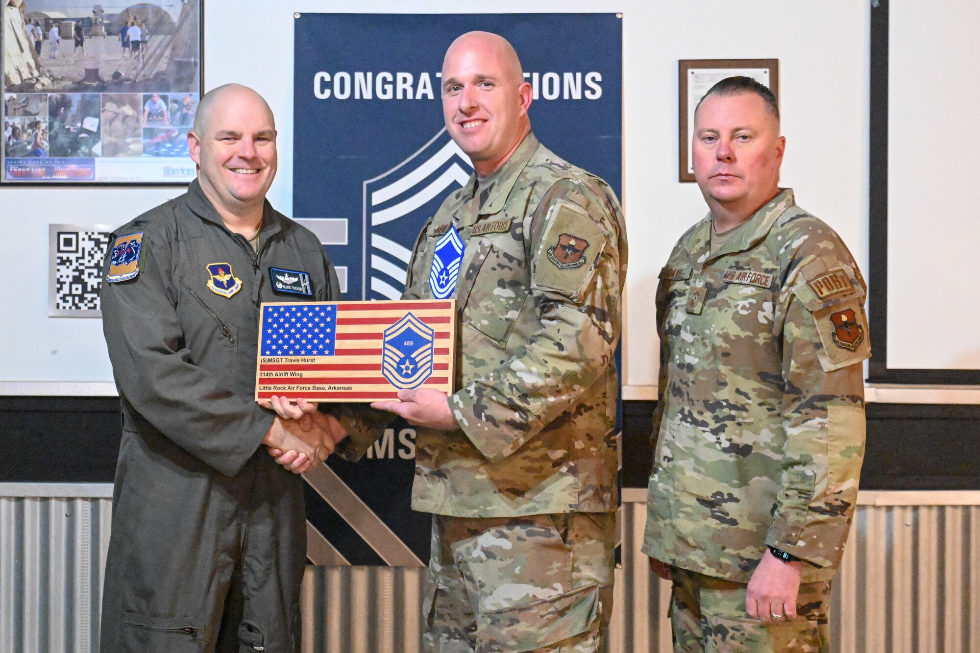 Men in uniform pose for a photo.