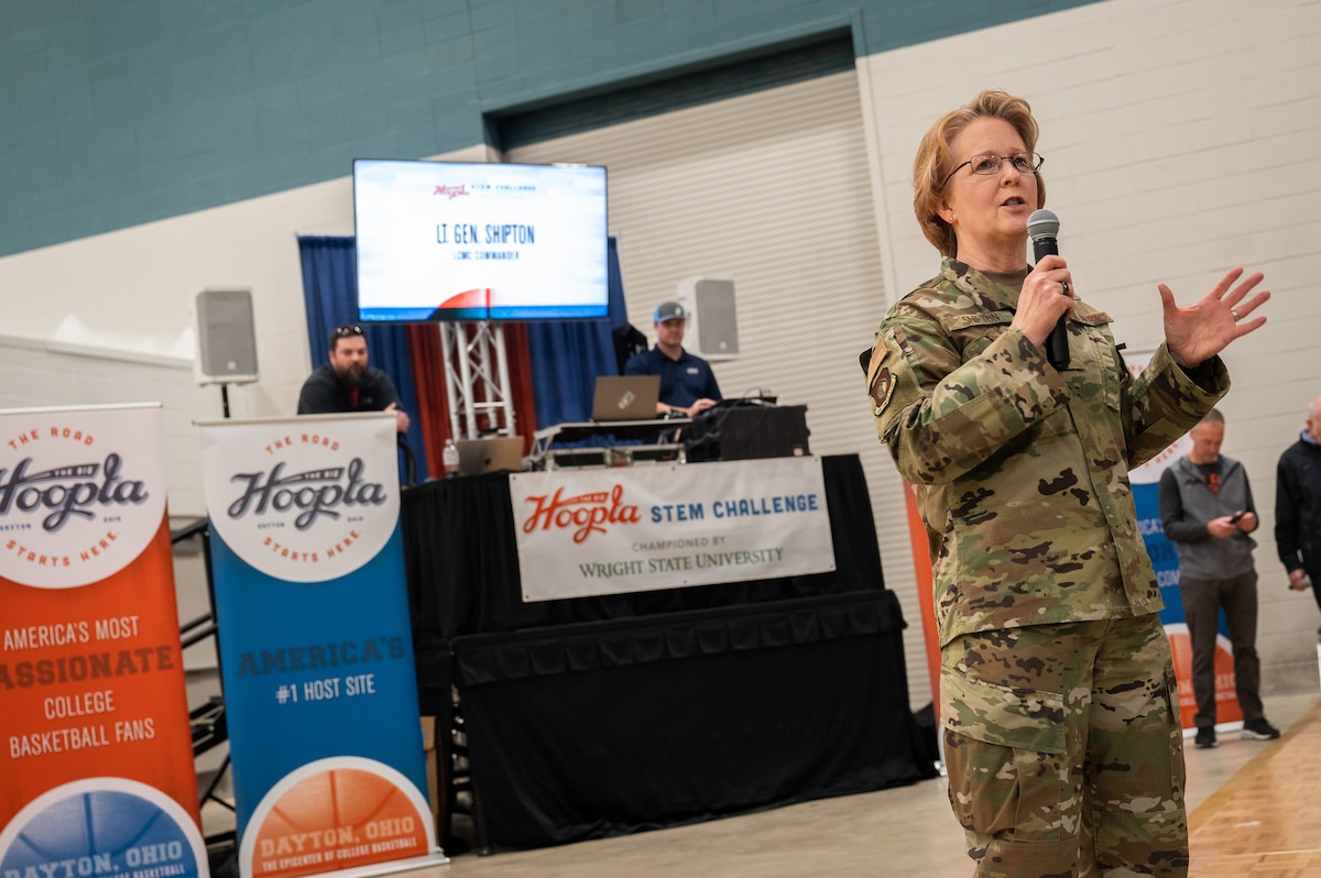 Woman wearing Air Force uniform talking to crowd.