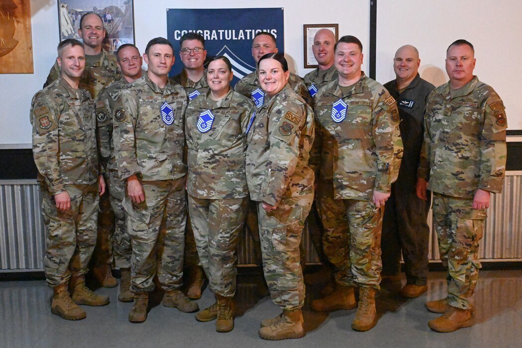 Airmen pose for a photo.