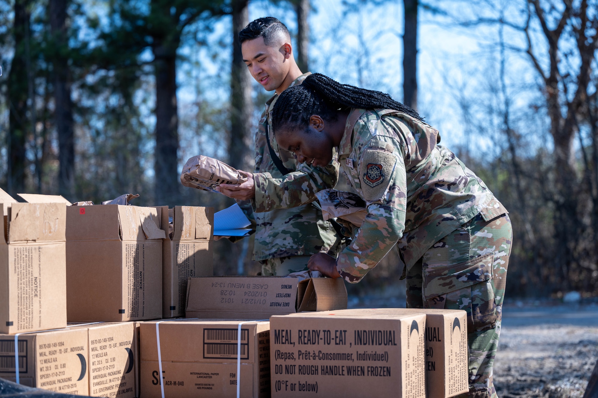 Airman go through boxes of Meal Ready-to-Eat during Combat Cardinal 2024.