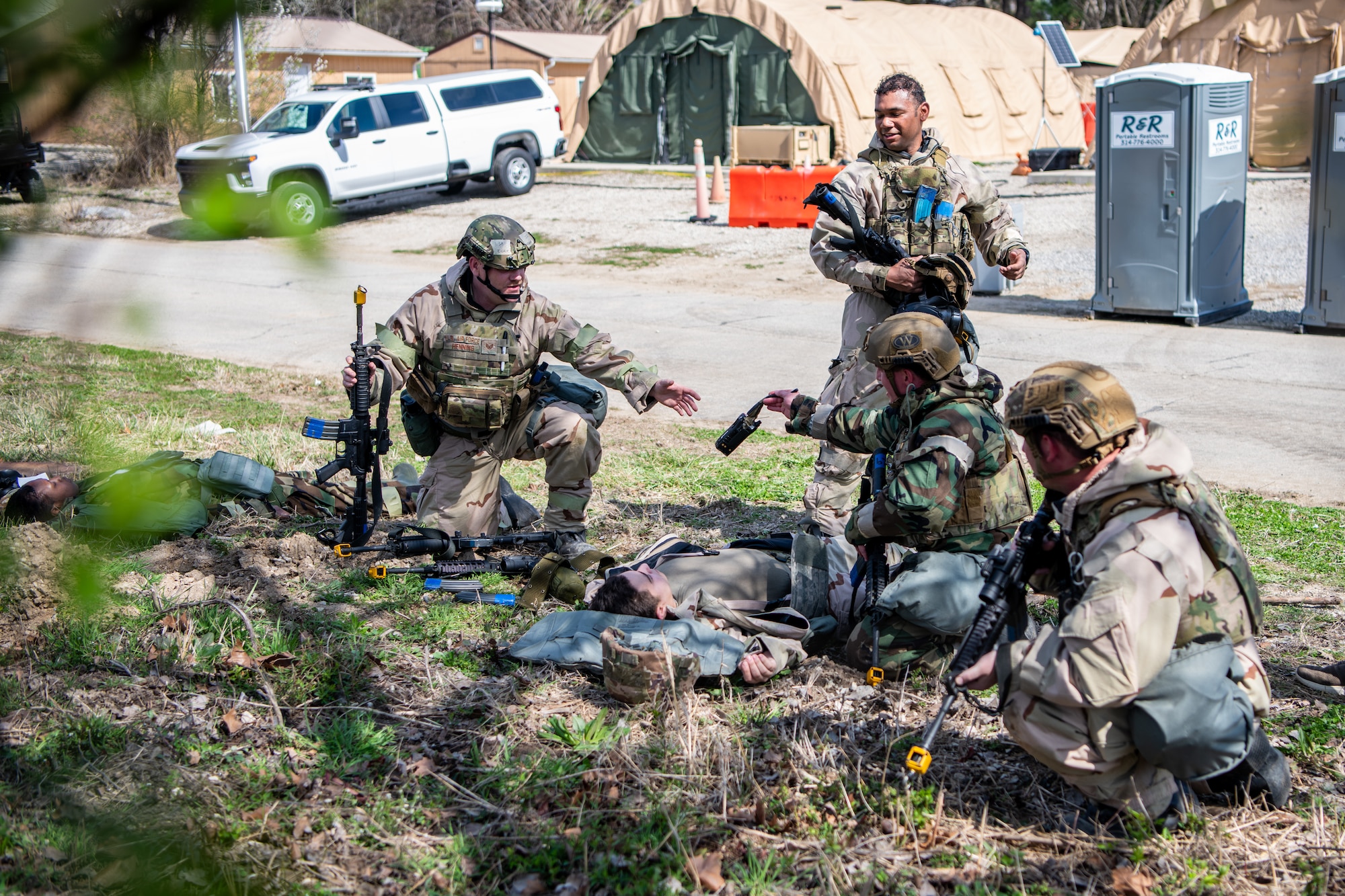 A group of Airmen simulate treating a casualty