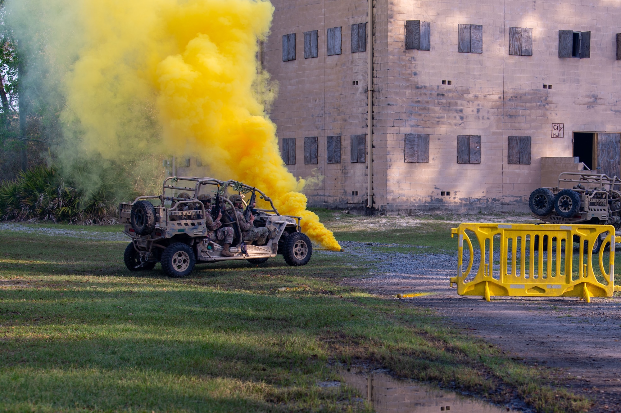 U.S. Air Force Airmen assigned to the 820th Base Defense Group signal the end of a tactical infiltration exercise with smoke at Moody Air Force Base, Georgia, March 15, 2024. As part of Women in Aviation Week, the 820 BDG gave ROTC cadets an opportunity to watch the exercise where they practiced clearing houses. Team Moody’s annual WIA events aim to highlight aviation-related career fields and inspire local youth to consider futures in the Air Force. (U.S. Air Force photo by Airman 1st Class Iain Stanley)