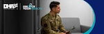 Uniformed Service Member smiles and sits on a couch with clipboard in hand.