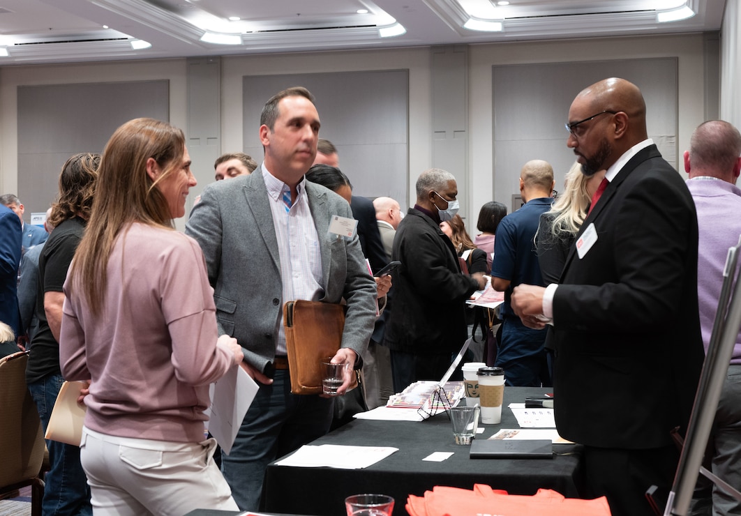 Attendees of the Sacramento District annual Business Opportunity Open House (BOOH) speak with Vernon Simpkins, Sacramento District Procurement Analyst, in Sacramento, California on March 5, 2024.