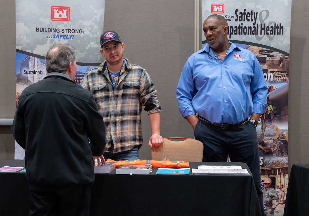 Attendees of the Sacramento District annual Business Opportunity Open House (BOOH) speak with Curtis Morris, Sacramento District Chief of Safety and Occupational Health and Joaquin Carrasco, Sacramento District Safety Specialist, in Sacramento, California on March 5, 2024.