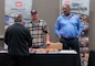 Attendees of the Sacramento District annual Business Opportunity Open House (BOOH) speak with Curtis Morris, Sacramento District Chief of Safety and Occupational Health and Joaquin Carrasco, Sacramento District Safety Specialist, in Sacramento, California on March 5, 2024.