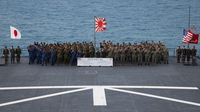 U.S Marines with the 31st Marine Expeditionary Unit, U.S. Navy Sailors with the America Amphibious Ready Group, Japanese Ground Self-Defense Force Soldiers, and Japan Maritime Self-Defense Force sailors pose for a group photo following the Iron Fist 24 closing ceremony aboard the Osumi-class tank landing ship JS Kunisaki (LST-4003) in Okinawa, Japan, Mar. 17, 2024. The closing ceremony concluded training between the armed forces and awarded servicemembers for outstanding performance during Iron Fist 24. Iron Fist is an annual bilateral exercise designed to increase interoperability and strengthen the relationships between the U.S. Marine Corps, the U.S. Navy, the Japanese Ground Self-Defense Force, and the Japanese Maritime Self-Defense Force. (U.S. Marine Corps photo by Cpl. Juan K. Maldonado)