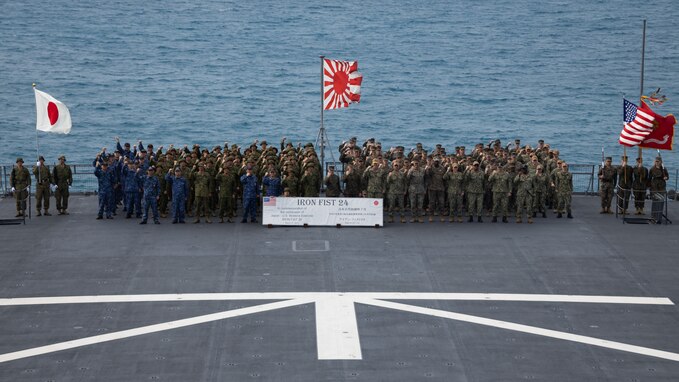 U.S Marines with the 31st Marine Expeditionary Unit, U.S. Navy Sailors with the America Amphibious Ready Group, Japanese Ground Self-Defense Force Soldiers, and Japan Maritime Self-Defense Force sailors pose for a group photo following the Iron Fist 24 closing ceremony aboard the Osumi-class tank landing ship JS Kunisaki (LST-4003) in Okinawa, Japan, Mar. 17, 2024. The closing ceremony concluded training between the armed forces and awarded servicemembers for outstanding performance during Iron Fist 24. Iron Fist is an annual bilateral exercise designed to increase interoperability and strengthen the relationships between the U.S. Marine Corps, the U.S. Navy, the Japanese Ground Self-Defense Force, and the Japanese Maritime Self-Defense Force. (U.S. Marine Corps photo by Cpl. Juan K. Maldonado)
