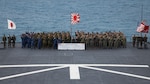 U.S Marines with the 31st Marine Expeditionary Unit, U.S. Navy Sailors with the America Amphibious Ready Group, Japanese Ground Self-Defense Force Soldiers, and Japan Maritime Self-Defense Force sailors pose for a group photo following the Iron Fist 24 closing ceremony aboard the Osumi-class tank landing ship JS Kunisaki (LST-4003) in Okinawa, Japan, Mar. 17, 2024. The closing ceremony concluded training between the armed forces and awarded servicemembers for outstanding performance during Iron Fist 24. Iron Fist is an annual bilateral exercise designed to increase interoperability and strengthen the relationships between the U.S. Marine Corps, the U.S. Navy, the Japanese Ground Self-Defense Force, and the Japanese Maritime Self-Defense Force. (U.S. Marine Corps photo by Cpl. Juan K. Maldonado)