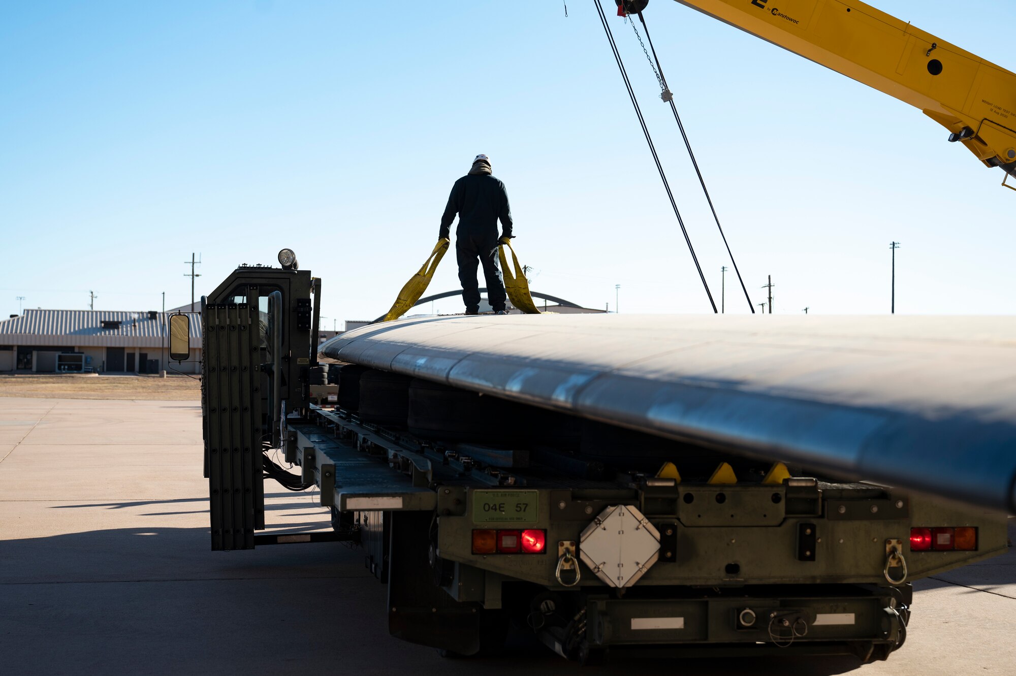 An Airman from the 76th Aircraft Maintenance Group’s Expeditionary Depot Maintenance Flight at Tinker Air Force Base secures the left wing from a B-1B Lancer on a truck at Dyess Air Force Base, Texas, Jan. 16, 2024. The left wing was transported to the 436th Training Squadron crash lab to support their aircraft mishap investigation course. (U.S. Air Force photo by Airman 1st Class Emma Anderson)