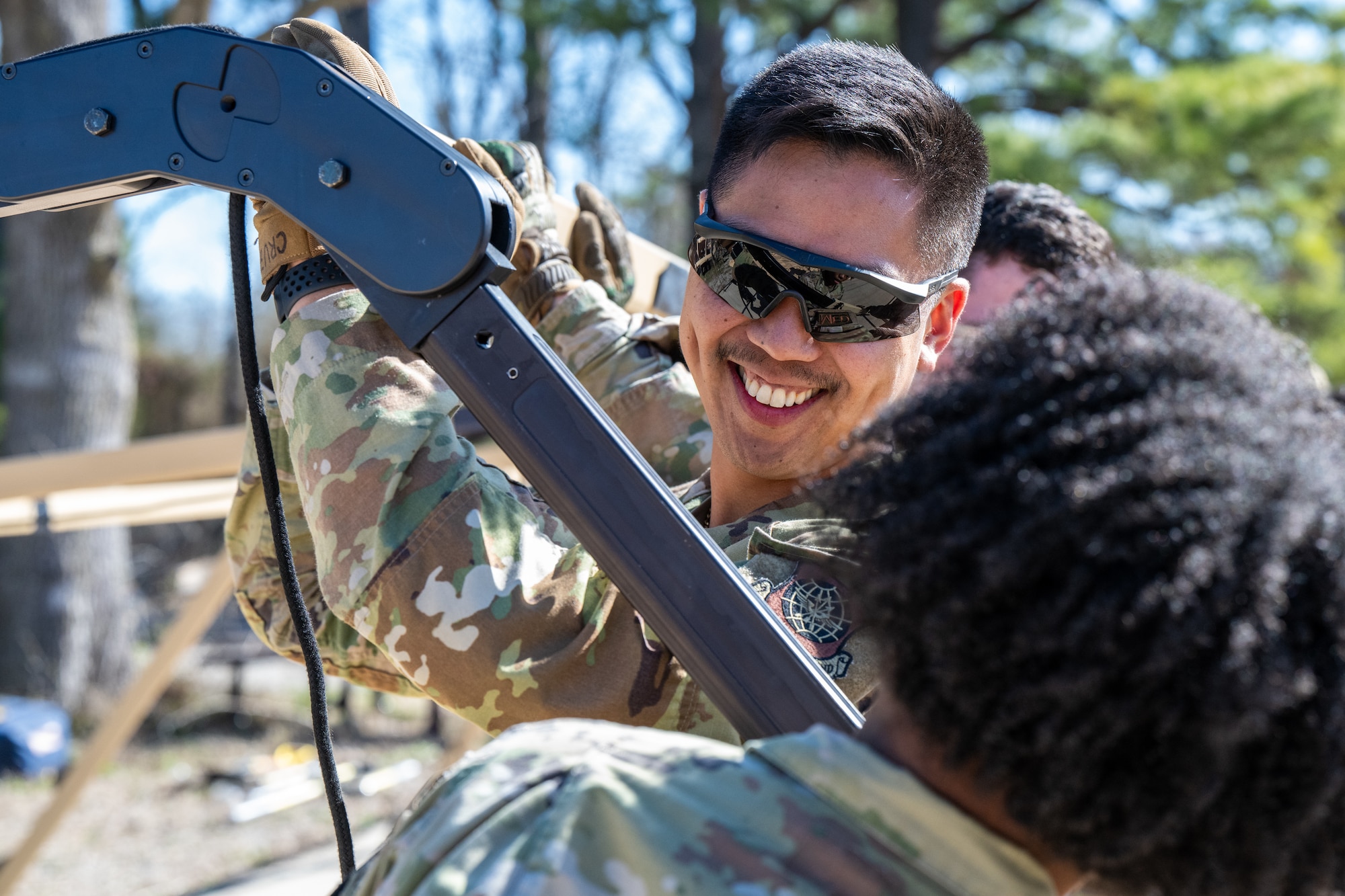 Airmen putting together a tent.
