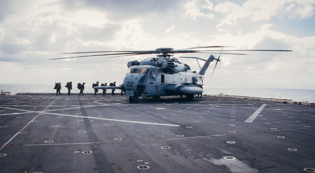 U.S. Marines assigned to the Ground Combat Element, 26th Marine Expeditionary Unit (Special Operations Capable) (MEU(SOC)), prepare to board a CH-53E Super Stallion while on the USS Mesa Verde (LPD 19, Mediterranean Sea, Feb. 18, 2024. U.S. Marines and Sailors with the 26th MEU(SOC), embarked aboard the ships of the Bataan Amphibious Ready Group (BATARG) conducted advanced ARG/MEU readiness sustainment training. U.S. Marines and Sailors with the 26th MEU(SOC), embarked aboard the ships of the Bataan Amphibious Ready Group (BATARG) conducted a five-day ARG/MEU readiness and sustainment training exercise focused on core mission essential tasks. The Bataan Amphibious Ready Group, with the embarked 26th MEU(SOC), is on a scheduled deployment in the U.S. Naval Forces Europe area of operations, employed by U.S. Sixth Fleet to defend U.S., Allied, and partner interests. (U.S. Marine Corps photo by Cpl. Aziza Kamuhanda)