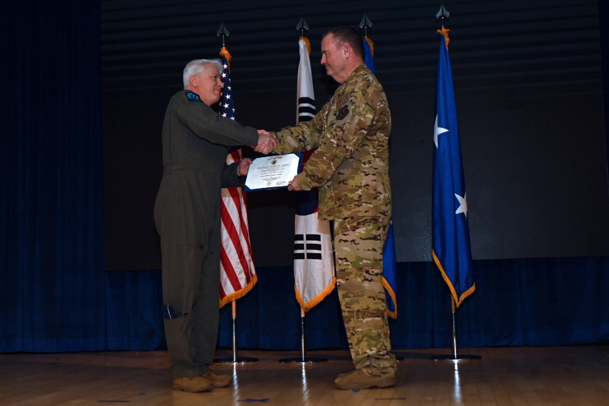 Maj. Gen. Erich Novak, Mobilization Assistant to the Commander, Pacific Air Forces, Joint Base Pearl Harbor-Hickam, Hawaii, left, shakes hands with Maj. Gen. Daniel Heires, Mobilization Assistant to the Commander, Air Component Command, United Nations Command; Commander, Air Component Command, Combined Forces Command; and Commander, 7th Air Force, right, after presenting the Distinguished Service Medal during General Heires’ retirement ceremony at Osan Air Base, Republic of Korea, March 15, 2024.