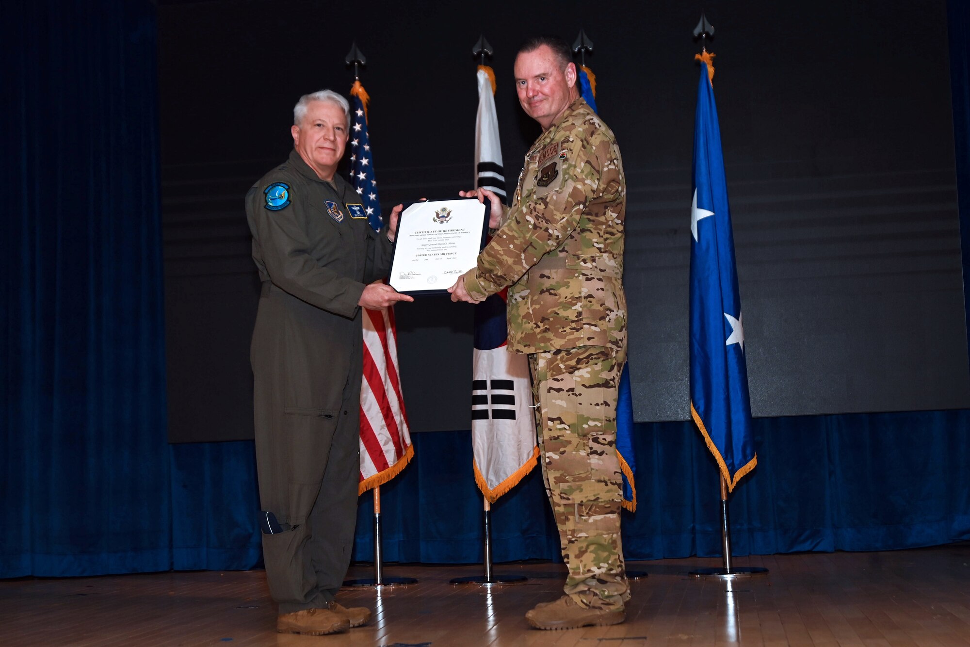 Maj. Gen. Erich Novak, Mobilization Assistant to the Commander, Pacific Air Forces, Joint Base Pearl Harbor-Hickam, Hawaii, left, presents the certificate of retirement to Maj. Gen. Daniel Heires, Mobilization Assistant to the Commander, Air Component Command, United Nations Command; Commander, Air Component Command, Combined Forces Command; and Commander, 7th Air Force, right, during General Heires’ retirement ceremony at Osan Air Base, Republic of Korea, March 15, 2024.