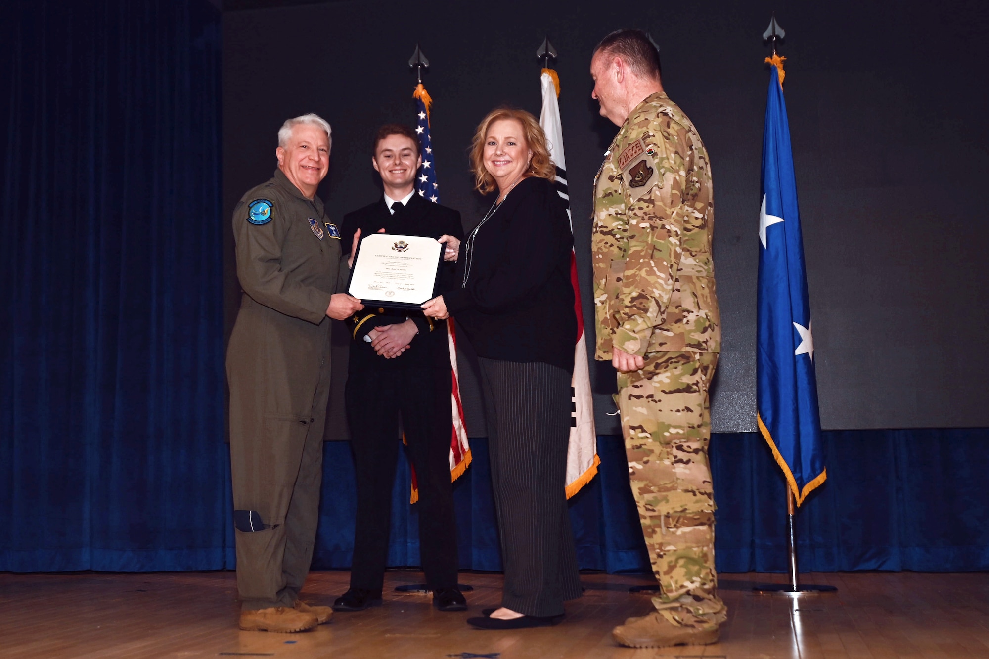 Maj. Gen. Erich Novak, Mobilization Assistant to the Commander, Pacific Air Forces, Joint Base Pearl Harbor-Hickam, Hawaii, left, presents a certificate of appreciation to Beth Heires, wife of Maj. Gen. Daniel Heires, Mobilization Assistant to the Commander, Air Component Command, United Nations Command; Commander, Air Component Command, Combined Forces Command; and Commander, 7th Air Force, right, during General Heires’ retirement ceremony at Osan Air Base, Republic of Korea, March 15, 2024.
