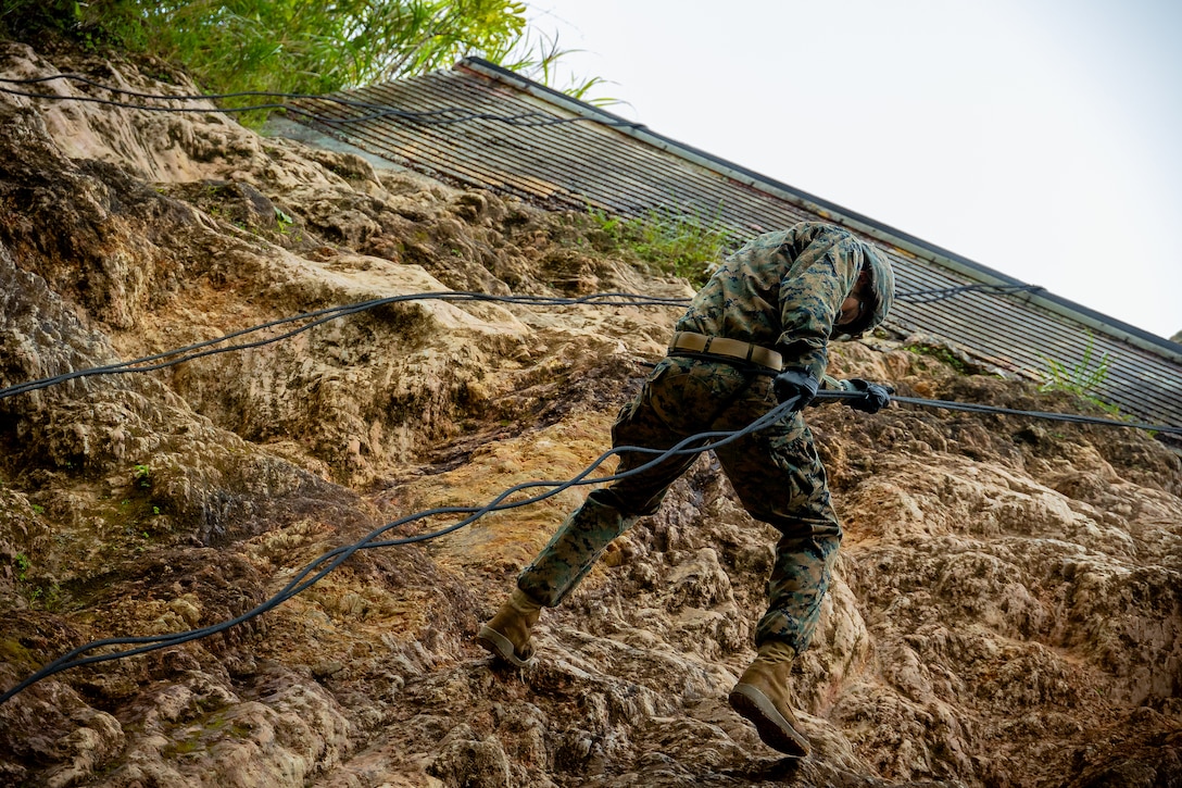 U.S. Navy Petty Officer 3rd Class Braydon Abbott rappels during a Jungle Religious Ministry Course (JREL) at the Jungle Warfare Training Center, Okinawa, Japan, Sept. 26, 2023. JREL is executed biannually to enhance the expeditionary skills of religious ministry personnel in an expeditionary advanced base jungle environment. Abbott is a U.S. Navy religious program specialist with Combat Logistics Battalion 31, 31st Marine Expeditionary Unit. (U.S. Marine Corps photo by Lance Cpl. Matthew Morales)