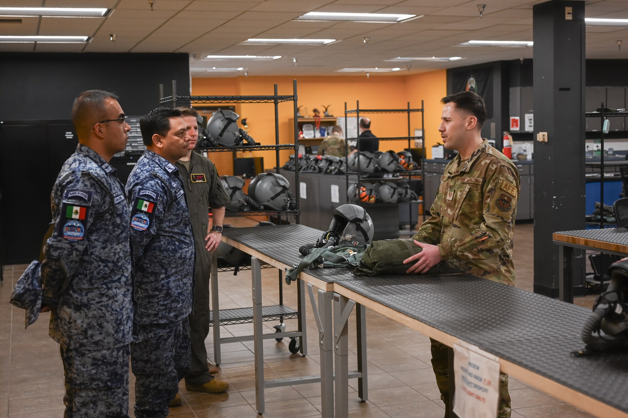 Mexican Air Force Brig. Gen. Disraeli Gomez Herrara, president of the Feria Aeroespecial Mexico (FAMEX), or the Mexico Aerospace Fair, speaks with Tech. Sgt. Vasquez Velez, 47th Operation Support Squadron aircrew flight equipment continuation training instructor, at Laughlin Air Force Base, Texas, March 6, 2024.