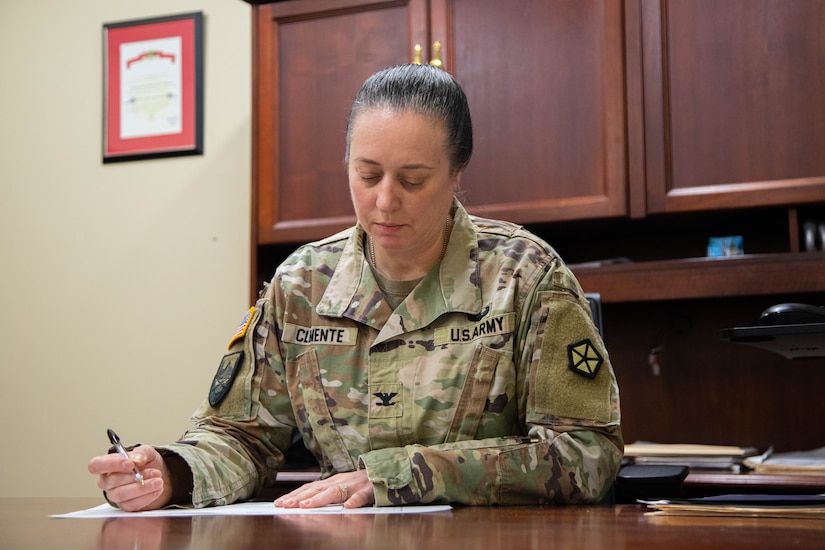 Col. Bonnie Clemente, the director of HR, looking over documents in the V Corps headquarters, March 8, 2024. Clemente leads a team of 24 Soldiers and civilians in providing personnel support to all V Corps military personnel, Department of the Army civilians and Family members.  (U.S. Army photo by Sgt. Javen Owens)