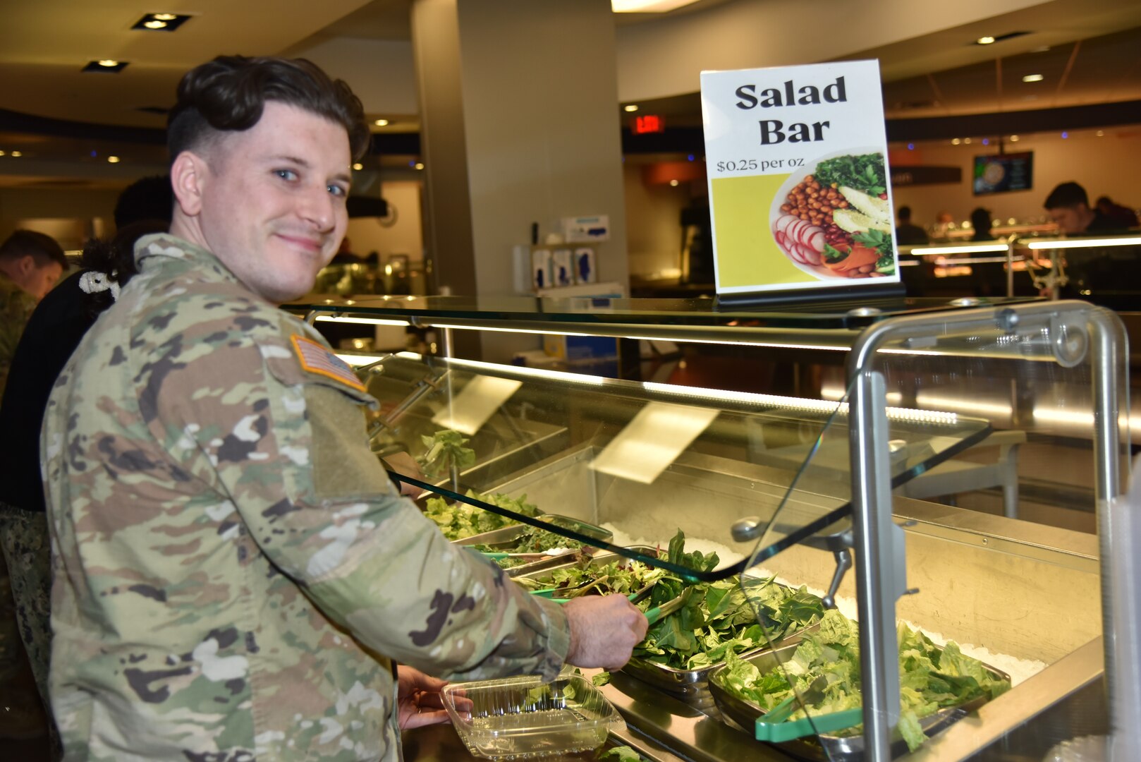 U.S. Army Cpt. Ryan P. Farley, the assistant chief of Food Service Operations at Walter Reed, is all smiles as he prepares his lunch at Cafe 8901 in Bethesda, Maryland.