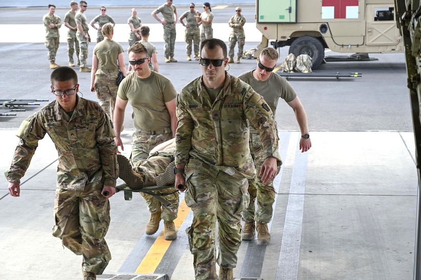 Combat medics from the 56th Stryker Brigade Combat Team who are deployed to the Horn of Africa conduct joint medical evacuation cold-load training aboard a KC-130J aircraft at Camp Lemonnier, Djibouti, March 5, 2024. The purpose of the training is to ensure interoperability with key U.S. military assets to expedite patient transfers to and from an aircraft in the event life saving measures and medical evacuation are requested. (U.S. Army National Guard photo by Capt. Amanda Mayer)