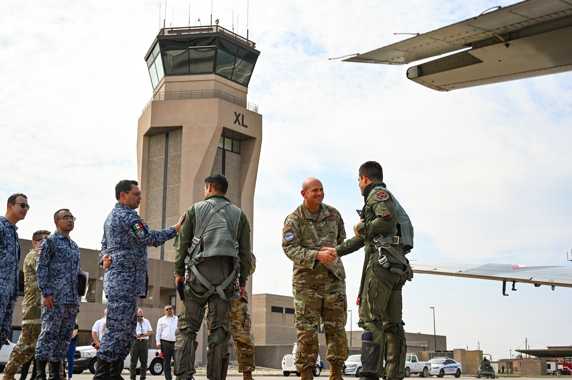 U.S. Air Force Col. Kevin Davidson, middle right, 47th Flying Training Wing commander and Mexican Air Force Brig. Gen. Disraeli Gomez Herrara, president of the Feria Aeroespecial Mexico (FAMEX), or the Mexico Aerospace Fair, far left, greet fellow Mexican Air Force pilots, middle left and far right, at Laughlin Air Force Base, Texas, March 6, 2024.