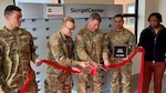 Image of a ribbon cutting ceremony in front of a machine