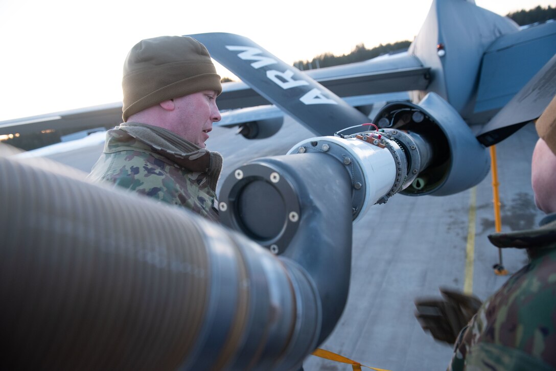 A maintenance airman inspects a drogue installation on a KC-135 Stratotanker boom at Luleå-Kallax Air Base, Swede