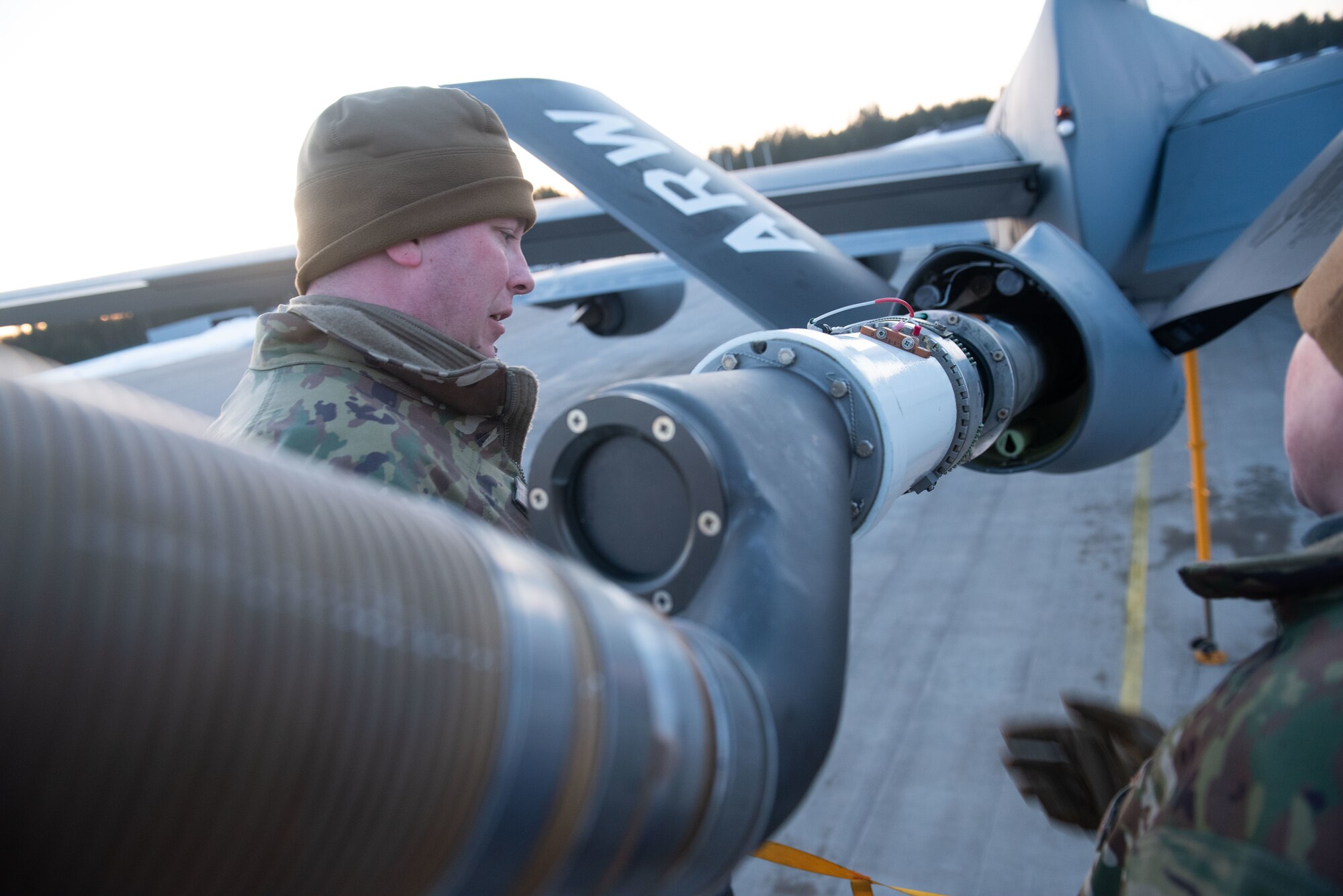 A maintenance airman inspects a drogue installation on a KC-135 Stratotanker boom at Luleå-Kallax Air Base, Swede