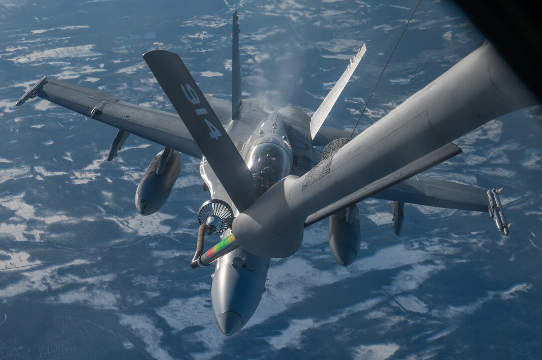 An F-18 is refueled over the High North