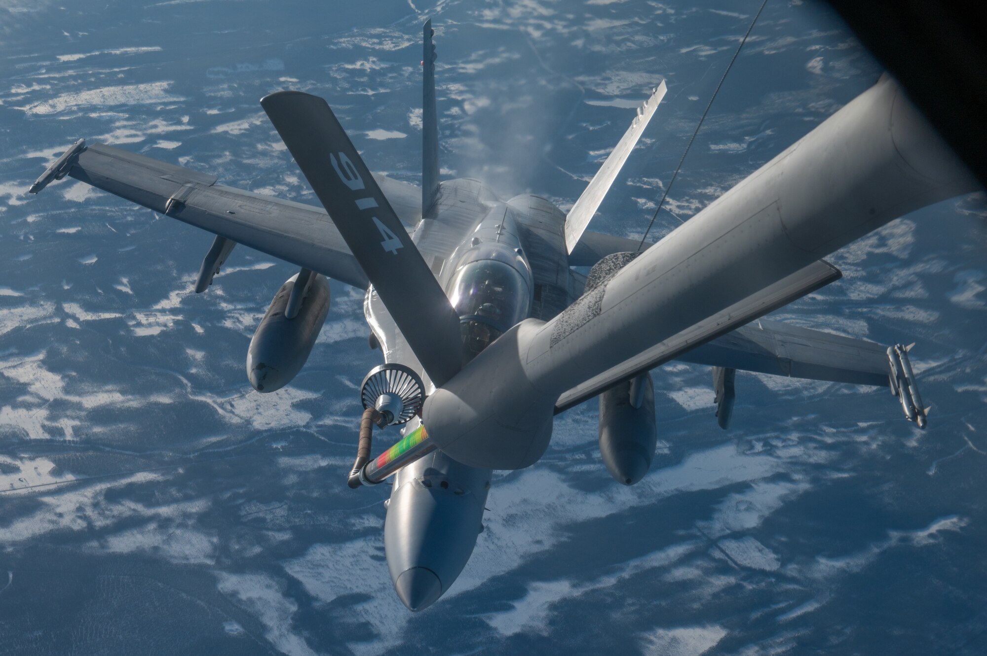 An F-18 is refueled over the High North