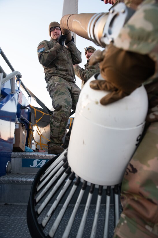 Maintenance Airmen install the drogue