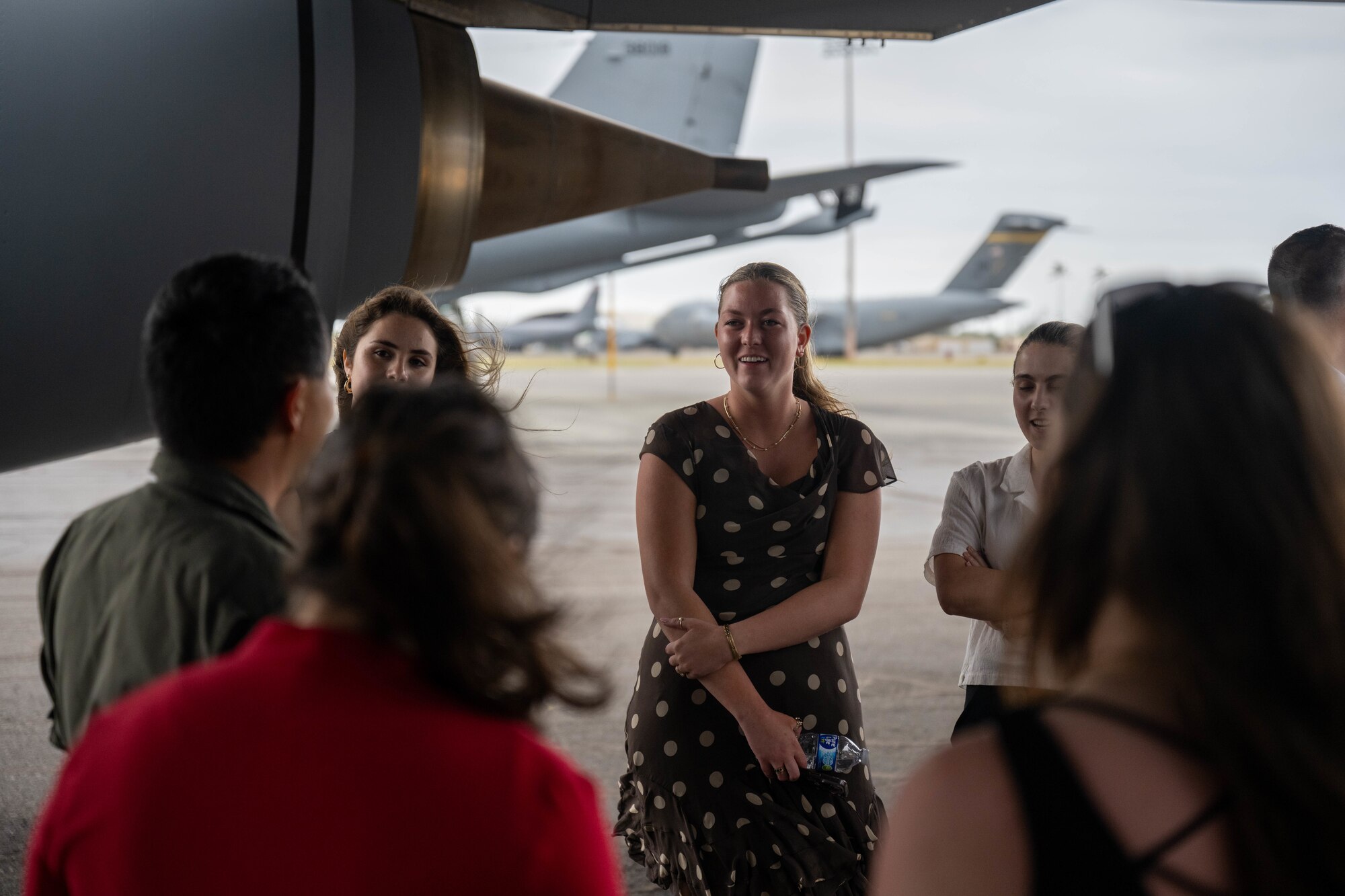 Woman smiles while in a group of people.