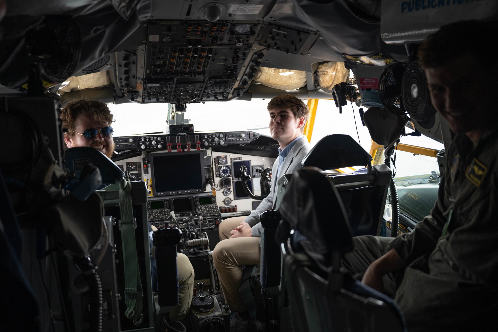 students sit in the cockpit of an aircraft.