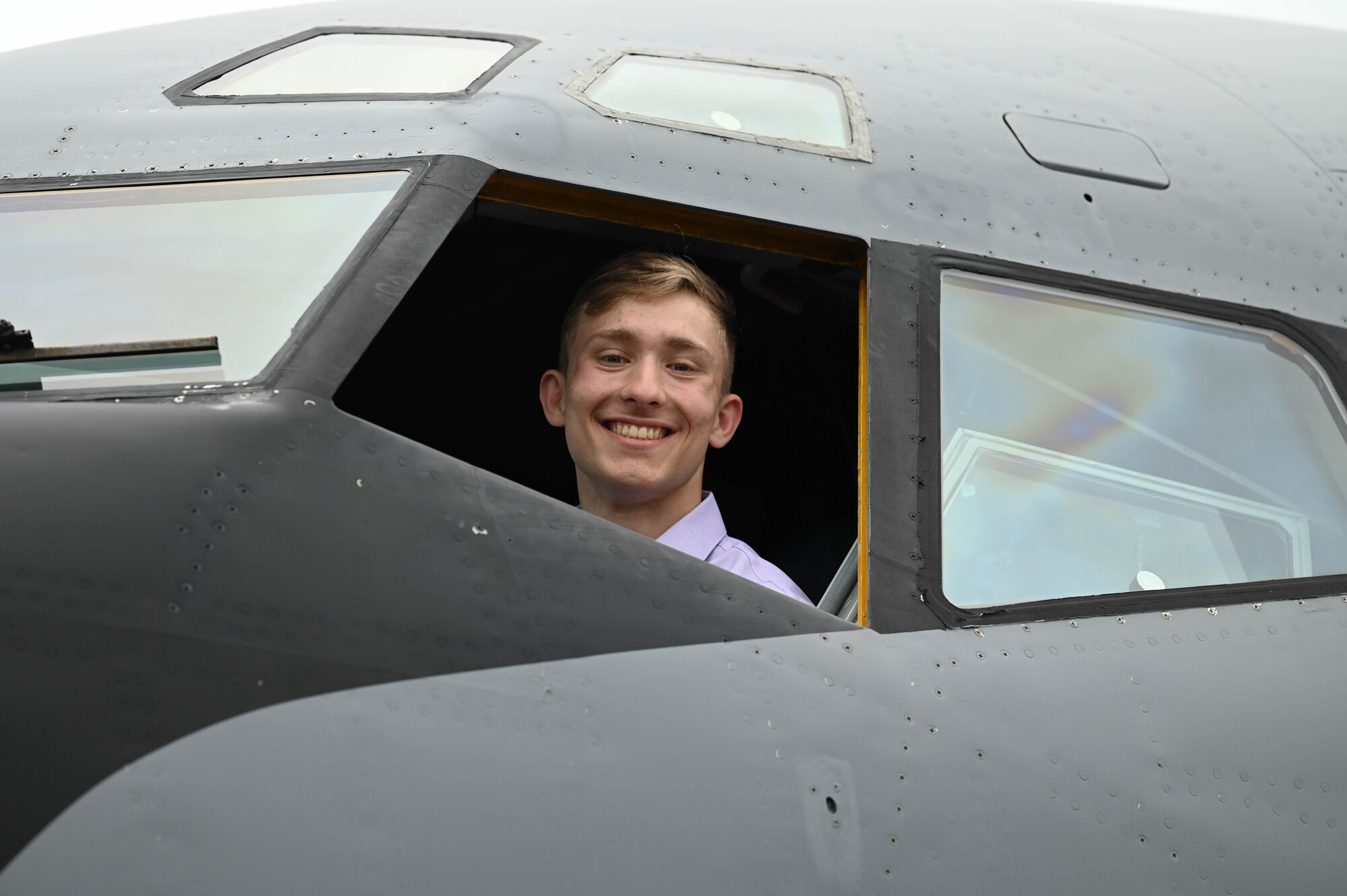 Man looks out the window of an aircraft.