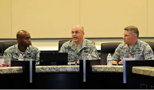 Chief Master Sgt. James (Bill) E. Fitch II, middle, responds to a question