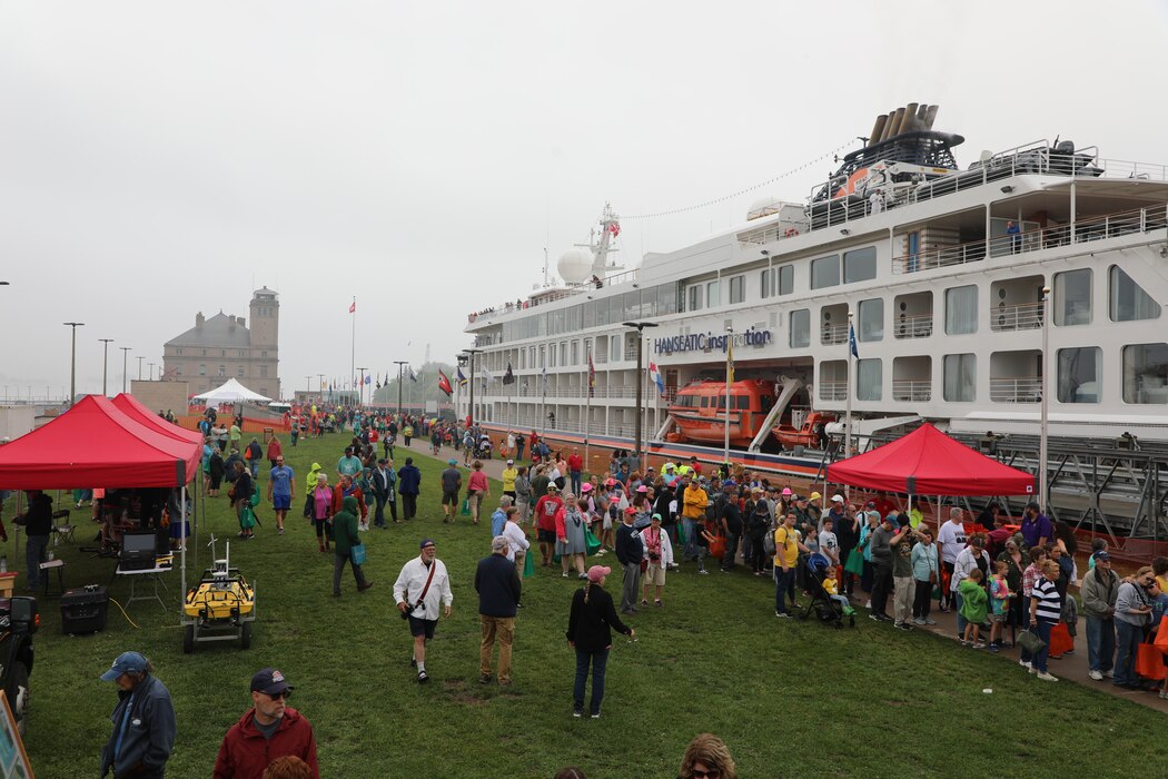 Visitors line up along the MacArthur Lock to watch the Hanseatic Inspiration cruise ship lock through the Soo Locks in Sault Ste. Marie, Michigan.