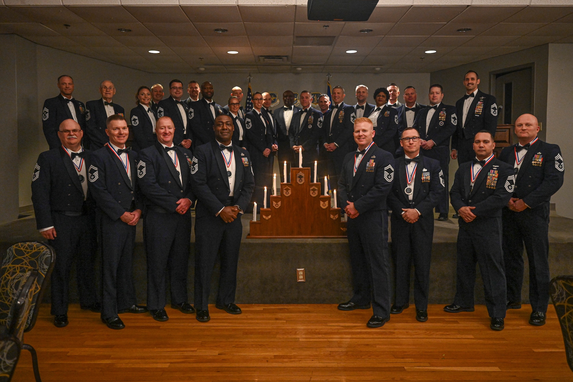 Airmen in uniform pose for a photo.