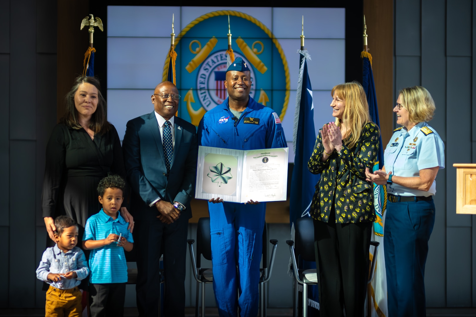 Cmdr. Andre Douglas, a NASA Astronaut, swears in to the Coast Guard Reserve during a commissioning ceremony presided over by Adm. Linda L. Fagan, commandant of the Coast Guard, at Coast Guard Headquarters in Washington, D.C., March 19, 2024. Douglas, a Coast Guard Academy Class of 2008 graduate, reported to NASA in January 2022, and completed astronaut training March 5, 2024.