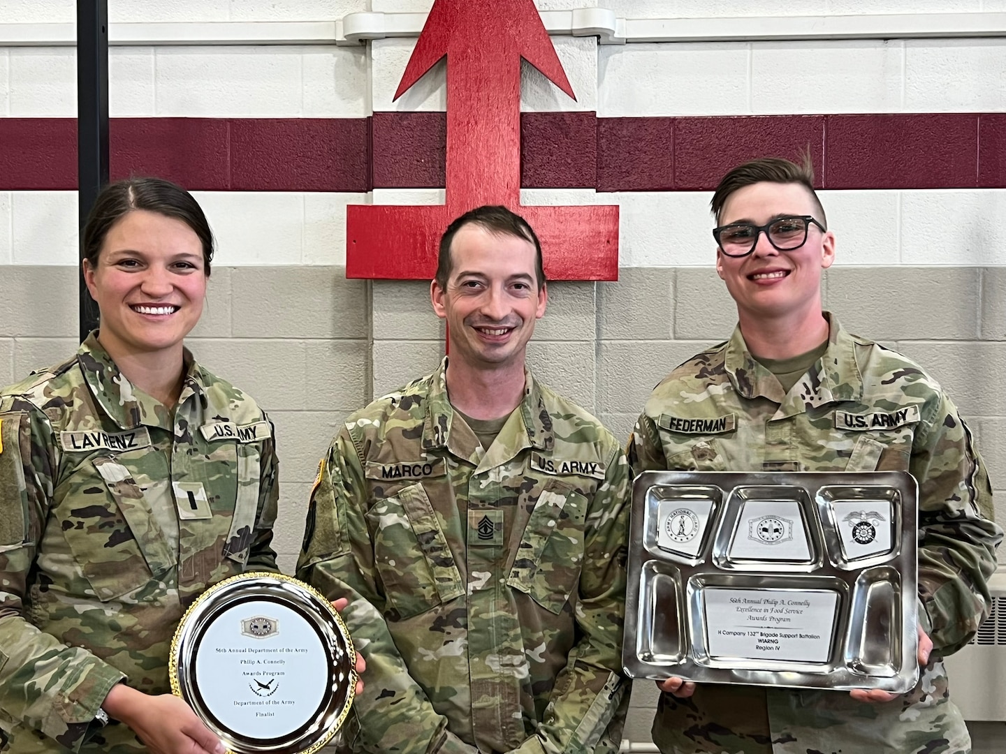 Hotel Company leadership, 1st Lt. Danielle Lavrenz (left), 1st Sgt. Roger Marco (center), and Sgt. 1st Class Dawn Federman (right), stand together for a group photo with memorabilia following their unit’s participation in the 56th Philip A. Connelly culinary competition at their Eau Claire armory on March 17, 2024. This Wisconsin Army National Guard unit was just one of four units that made it to the final level of the competition for fiscal year 24. (U.S. National Guard photo by Sgt. Nina Kowalkowski)