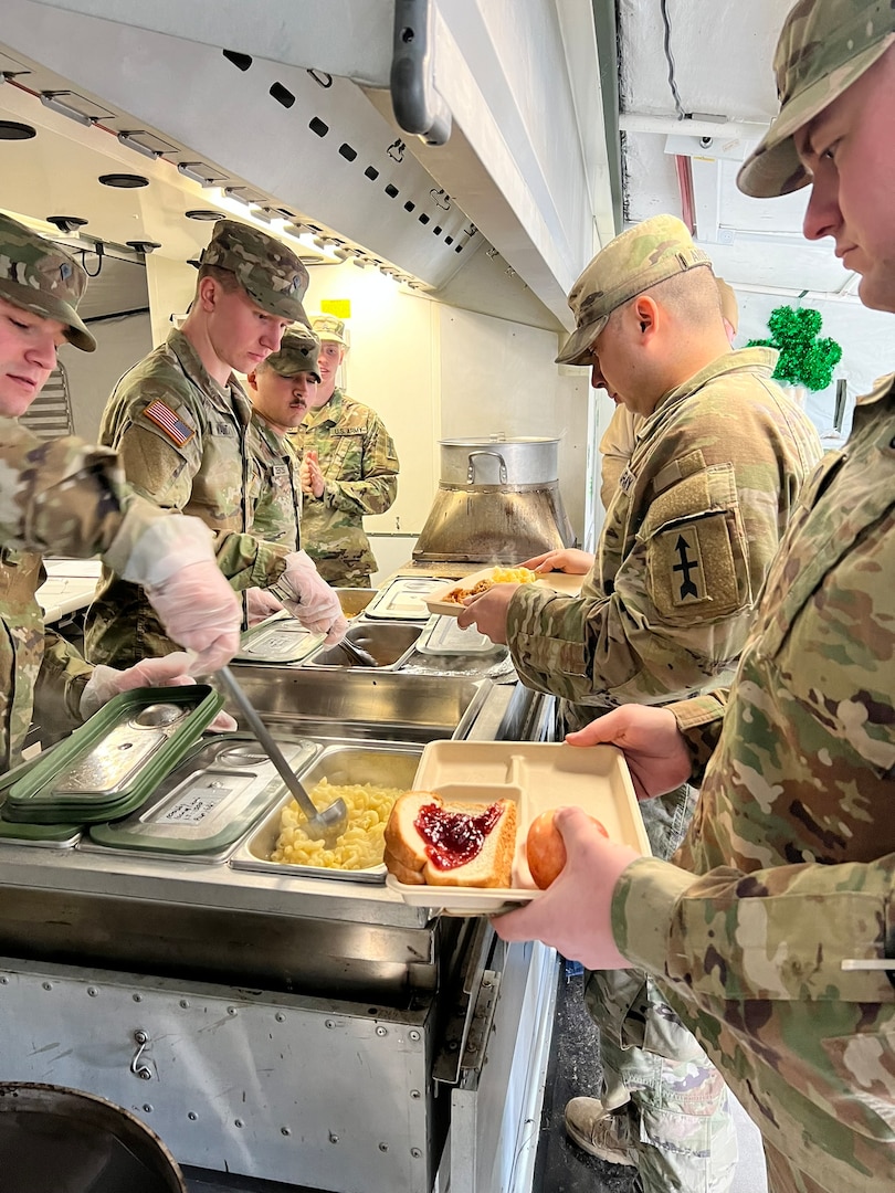 Members of Hotel Company, 132nd Brigade Support Battalion, serve their lunch consisting of breaded shrimp, pasta with primavera sauce, and salad for judgement in the 56th Philip A. Connelly culinary competition at their Eau Claire armory on March 17, 2024. This Wisconsin Army National Guard unit was just one of four units that made it to the final level of the competition for fiscal year 24. (U.S. National Guard photo by Sgt. Nina Kowalkowski)