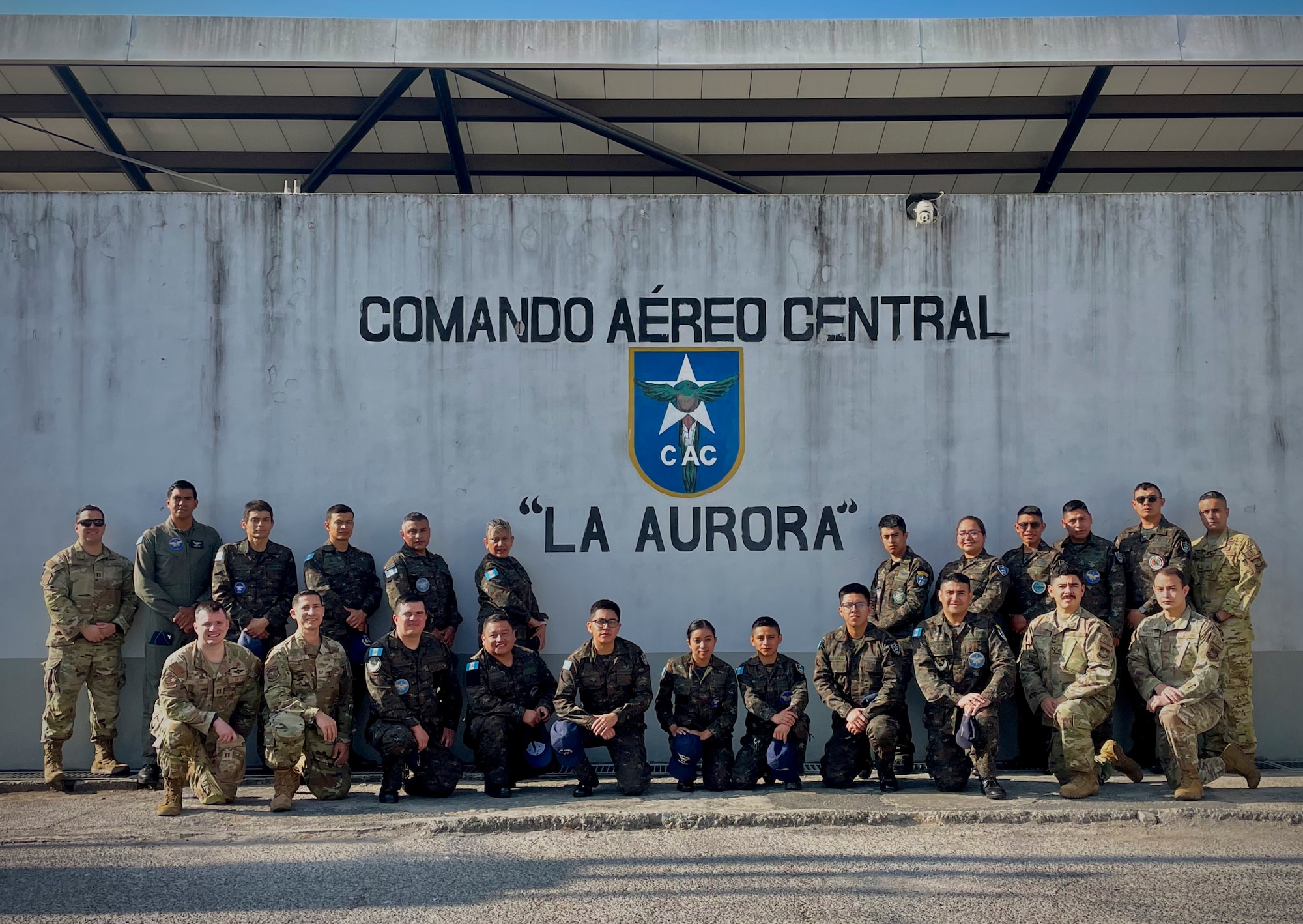 Military service members with the 571st Mobility Support Advisory Squadron and Comando Aéreo Central (CACEN) pose for a photo during a base tour at CACEN “La Aurora” in Guatemala City, Guatemala, Feb. 20, 2024
