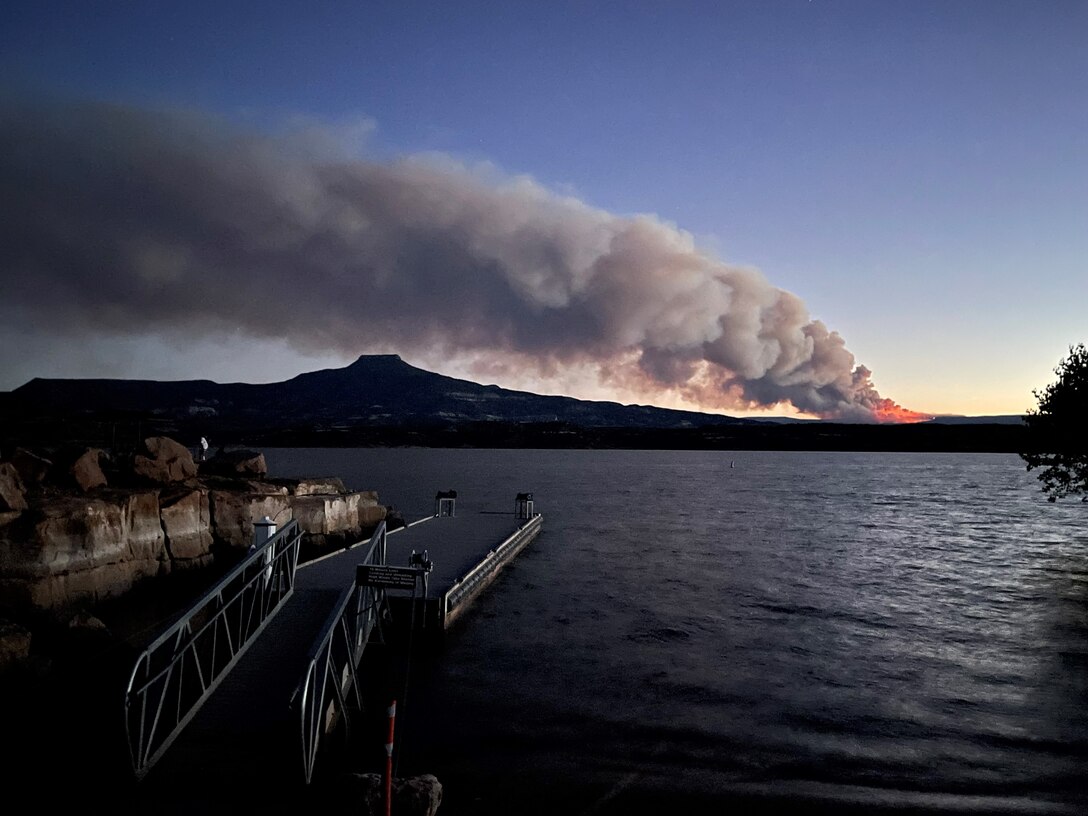 The Black Feather Fire reflects in Abiquiu Lake, Aug. 6, 2023. The fire burned approximately 2,200 acres in Rio Arriba, County, N.M., in August 2023.