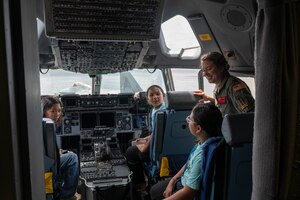 Person talks to kids inside aircraft.