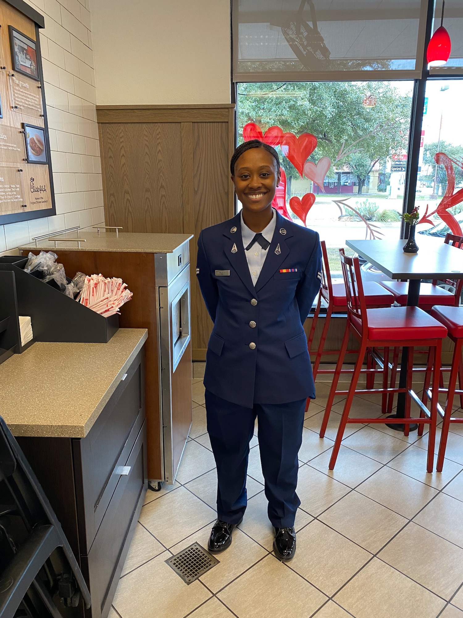 U.S. Space Force Spc. 3 Shayla Wiley, 74th Intelligence, Surveillance and Reconnaissance stands alone in a restaurant wearing Space Force blues.