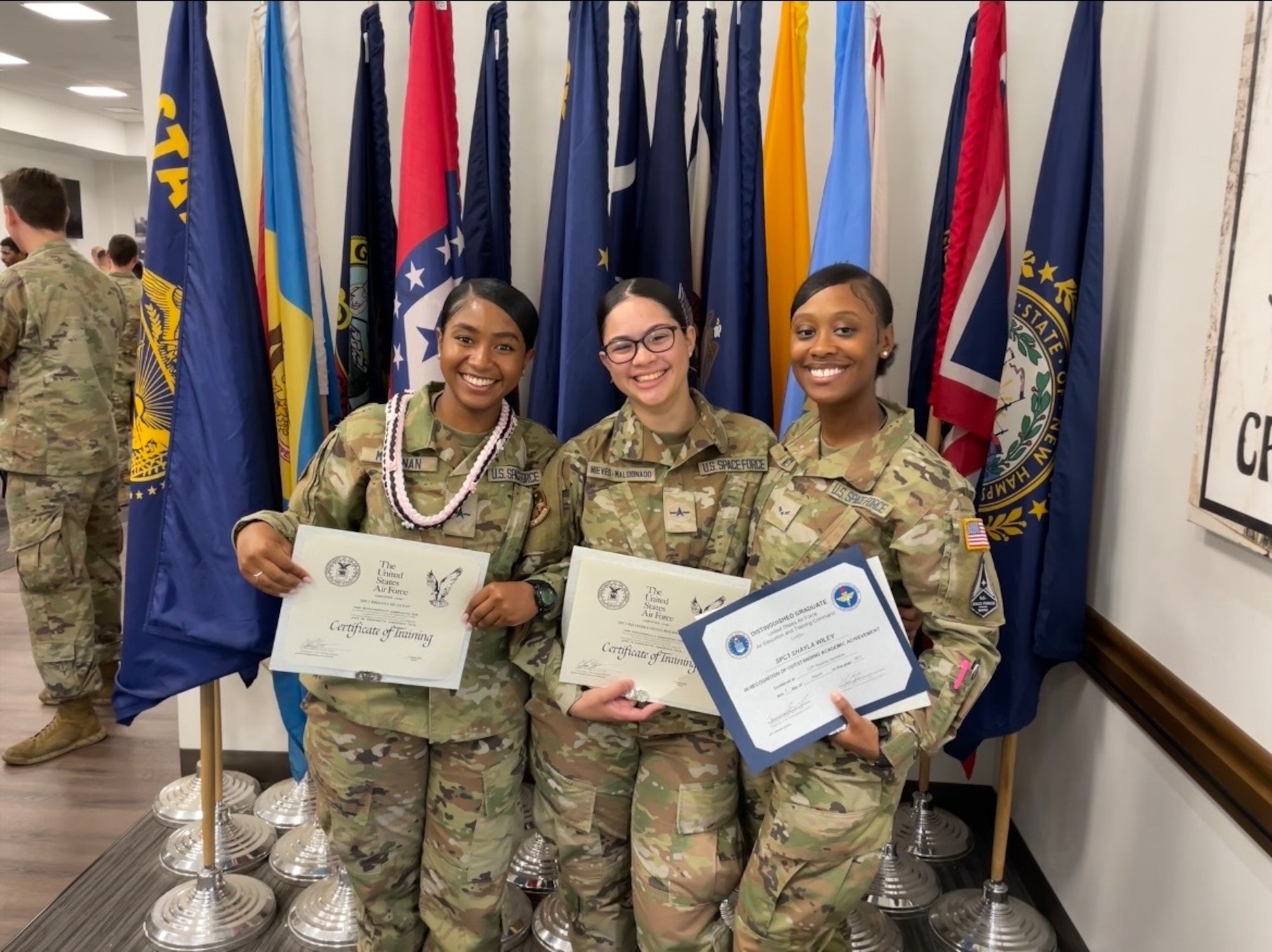 U.S. Space Force Spc. 3 Shayla Wiley, 74th Intelligence, Surveillance and Reconnaissance stands next to two other Guardians holding a training certificate.
