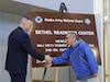 Maj. Gen. Torrence Saxe, the adjutant general of the Alaska National Guard congratulates retired AKARNG Soldier Maj. Robert Hoffman after unveiling the a new sign during a dedication ceremony held at the Bethel Readiness Center Mar. 15, 2024. Hoffman was joined by his loved ones, community members and fellow servicemembers in a celebration of his character and selfless leadership throughout his military career. (Alaska National Guard photo by Seth LaCount)