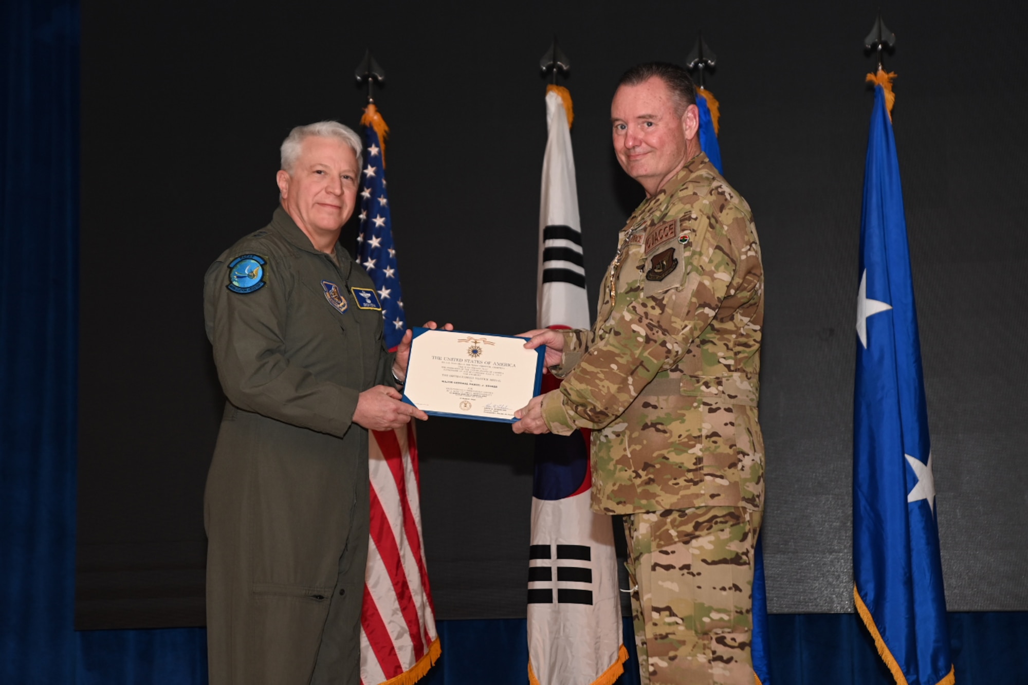 Maj. Gen. Erich Novak, Mobilization Assistant to the Commander, Pacific Air Forces, Joint Base Pearl Harbor-Hickam, Hawaii, left, presents the Distinguished Service Medal to Maj. Gen. Daniel Heires, Mobilization Assistant to the Commander, Air Component Command, United Nations Command; Commander, Air Component Command, Combined Forces Command; and Commander, 7th Air Force, right, during General Heires’ retirement ceremony at Osan Air Base, Republic of Korea, March 15, 2024.