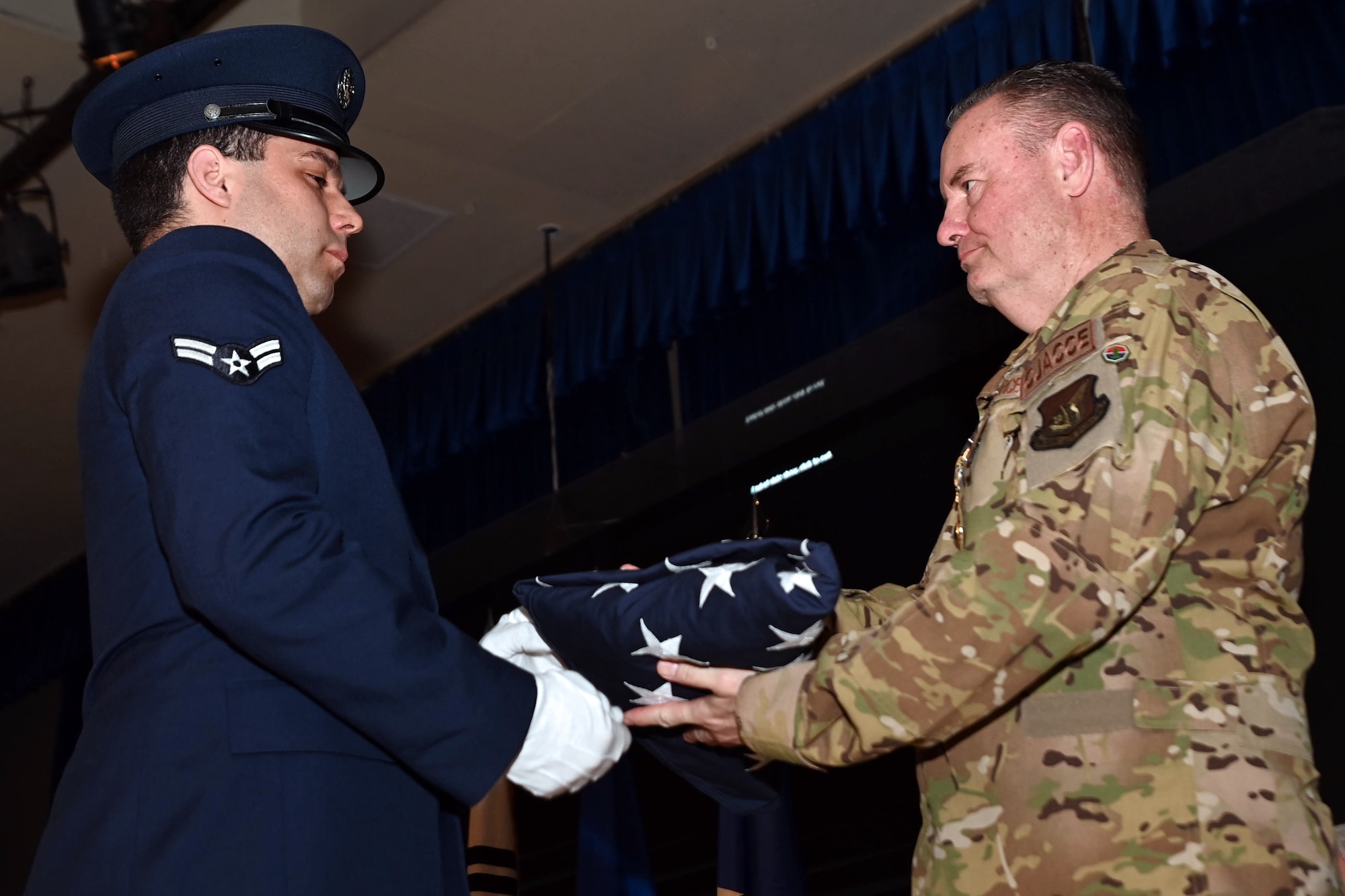 Osan Honor Guard member Airman 1st Class Eryk Martin, 51st Operations Support Squadron, presents a U.S. flag to Maj. Gen. Daniel Heires, Mobilization Assistant to the Commander, Air Component Command, United Nations Command; Commander, Air Component Command, Combined Forces Command; and Commander, 7th Air Force, right, during General Heires’ retirement ceremony at Osan Air Base, Republic of Korea, March 15, 2024.